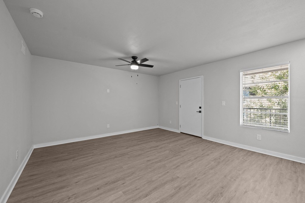 an empty living room with a ceiling fan and a window at Sunset Heights, San Antonio, 78209