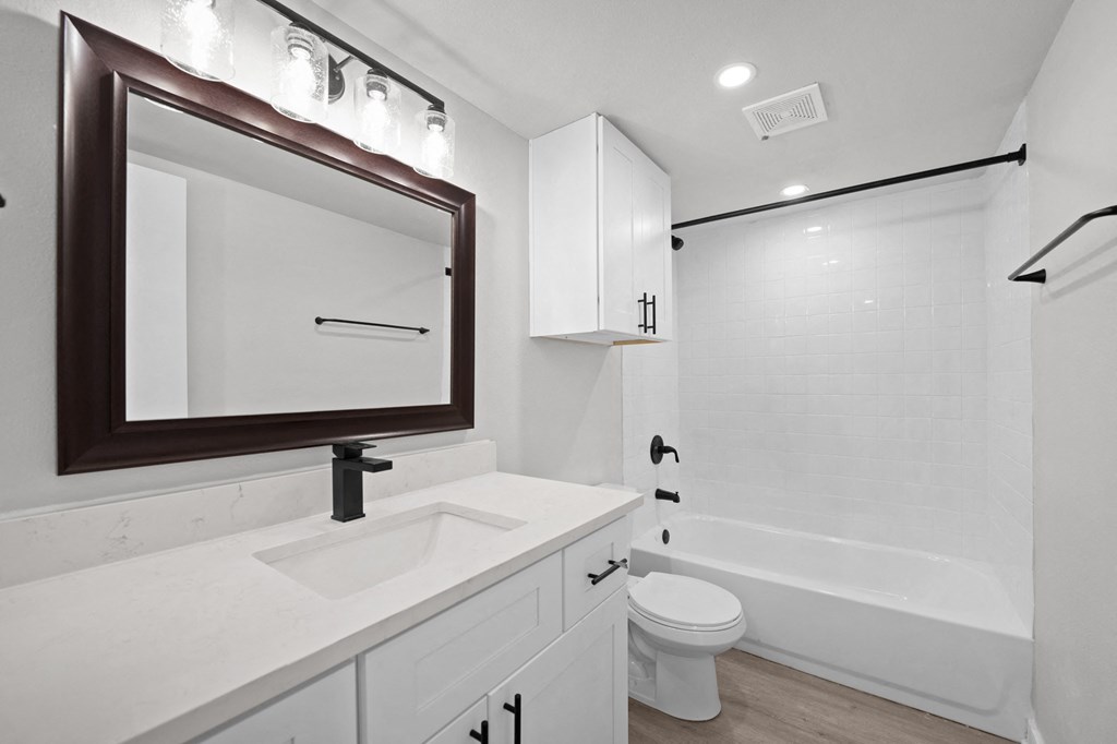 a bathroom with a sink and a toilet and a shower at Sunset Heights, Texas