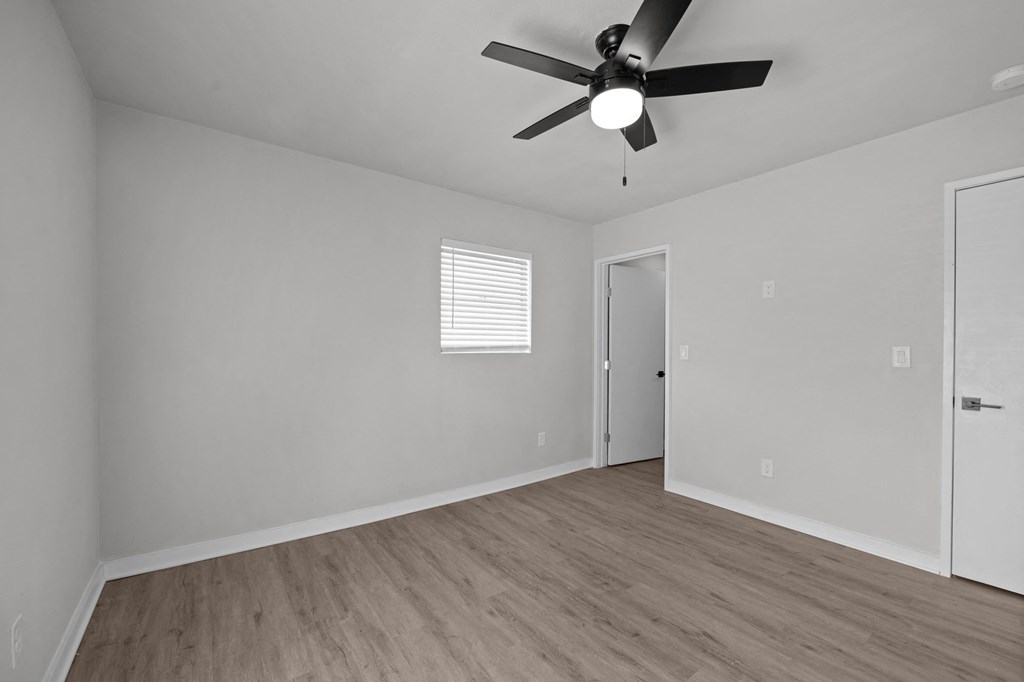 Photo of renovated bedroom with ceiling fan and vinyl flooring at Sunset Heights, San Antonio