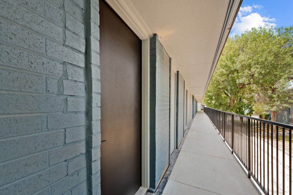 a long balcony with a metal fence on the side of a building at Sunset Heights, San Antonio