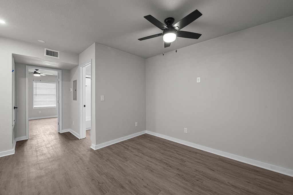 Photo of renovated bedroom with ceiling fan and vinyl flooring at Sunset Heights, San Antonio