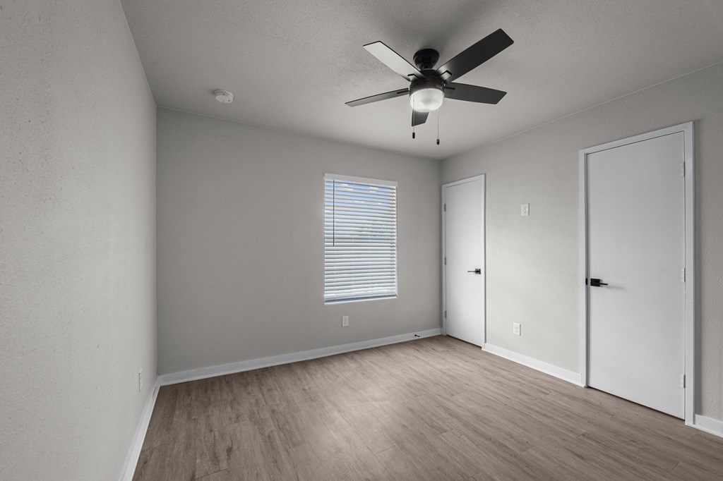 Photo of newly renovated bedroom with vinyl flooring and ceiling fan at Sunset Heights, San Antonio, 78209