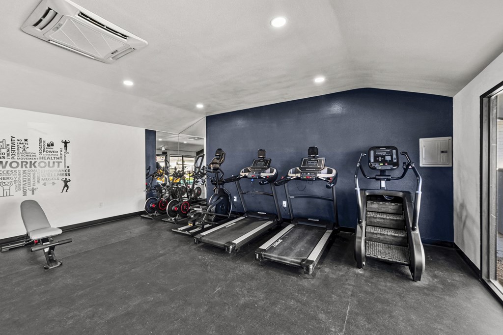 a fitness room with treadmills and bikes at Peaks at Live Oak in San Antonio, TX