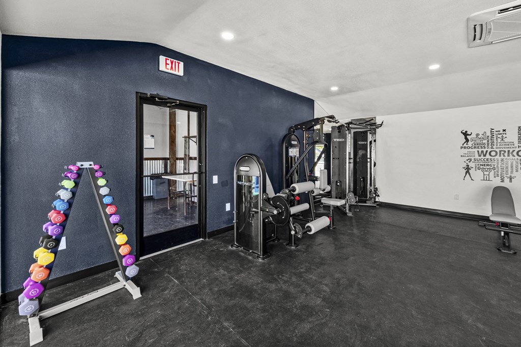 a fitness room with weights and cardio equipment at Peaks at Live Oak in San Antonio, TX