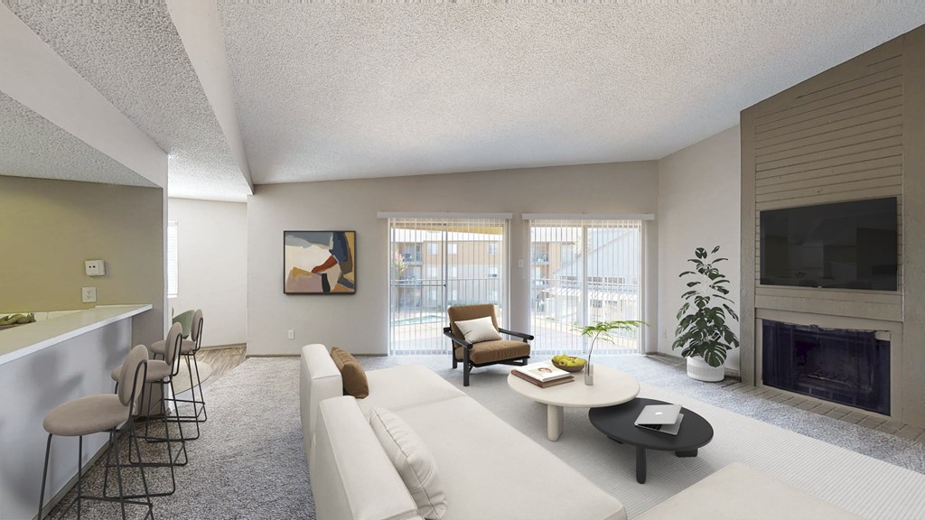 A living room with a white couch, a coffee table, and a fireplace.