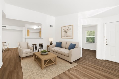 A living room with a couch, chairs, and a coffee table.