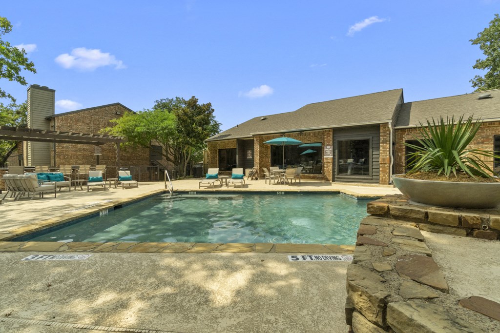 a swimming pool with a house in the background