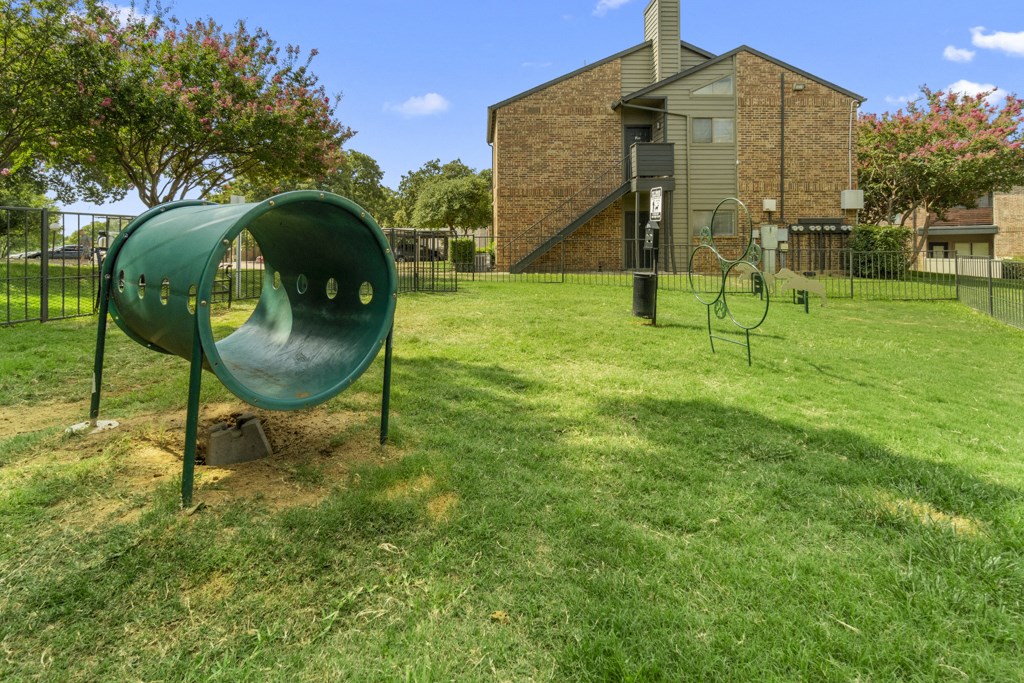 the yard is equipped with a playground and a basketball hoop