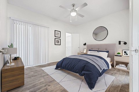 a bedroom with a bed and a ceiling fan