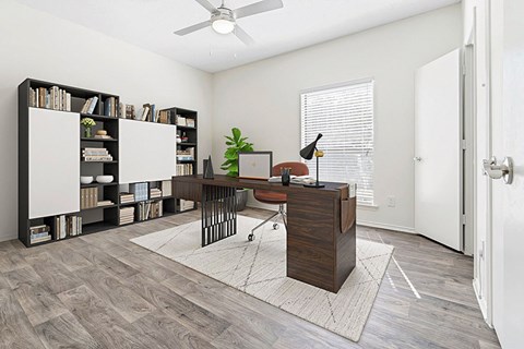 an office with a large window and a desk with a computer
