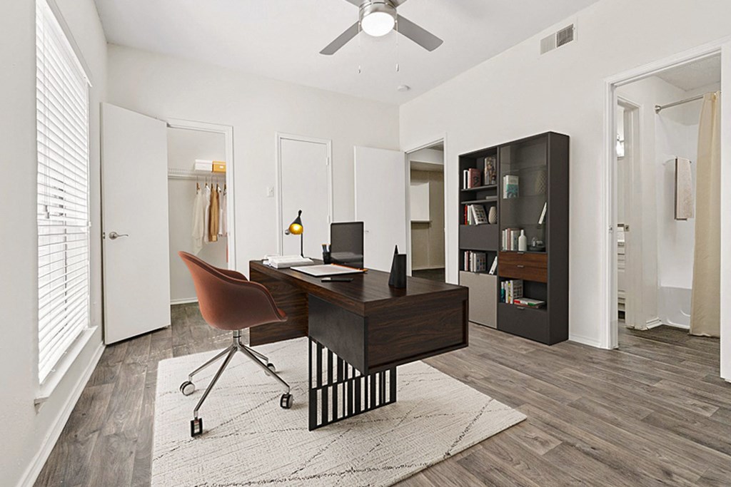 the residence on lamar apartment homes has an office with a desk and a chair