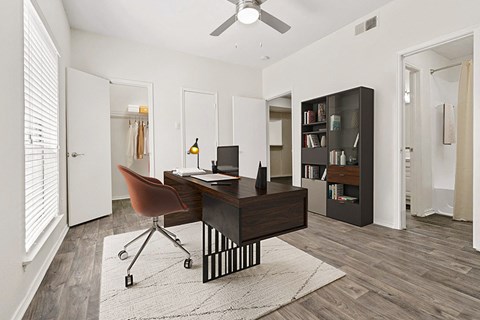 the residence on lamar apartment homes has an office with a desk and a chair