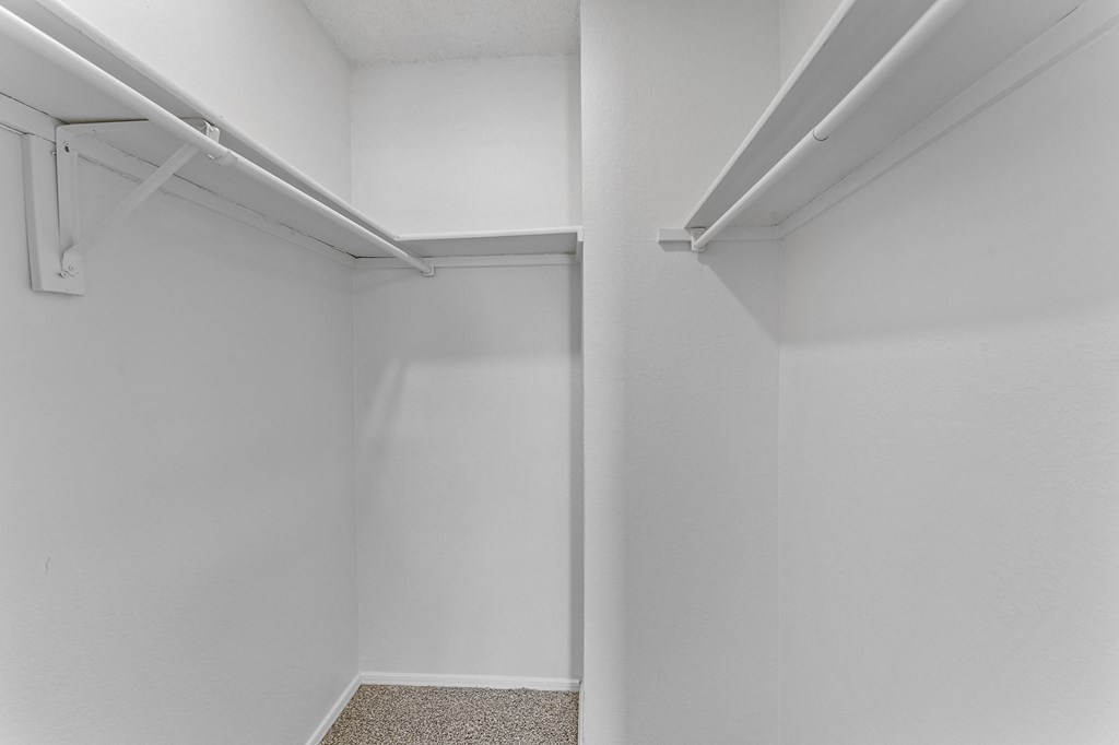 a spacious walk in closet in a 555 waverly unit at The Hills at Ironhorse, North Richland Hills, TX