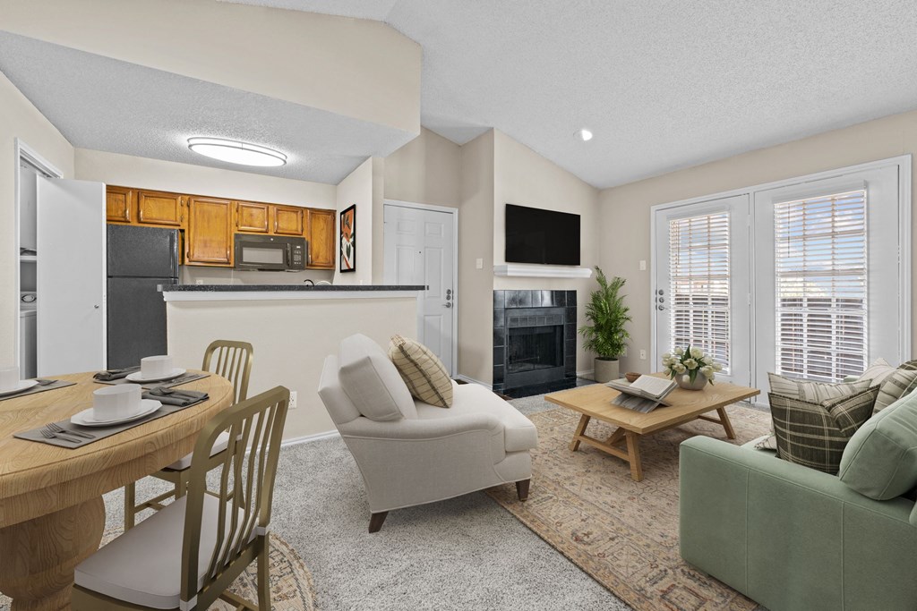 a living room with a couch a chair a table and a fireplace at Preston Bend, Dallas, TX, 75252