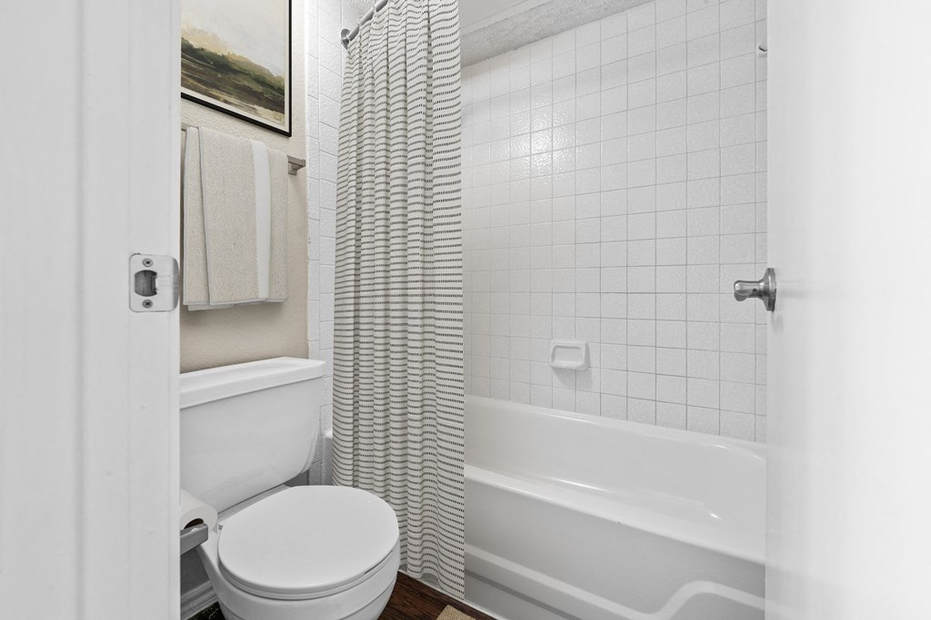 a bathroom with a toilet and a bathtub at Preston Bend, Dallas, Texas
