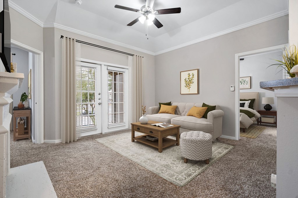a living room with a couch and a coffee table at Fountains of Denton in Denton, TX