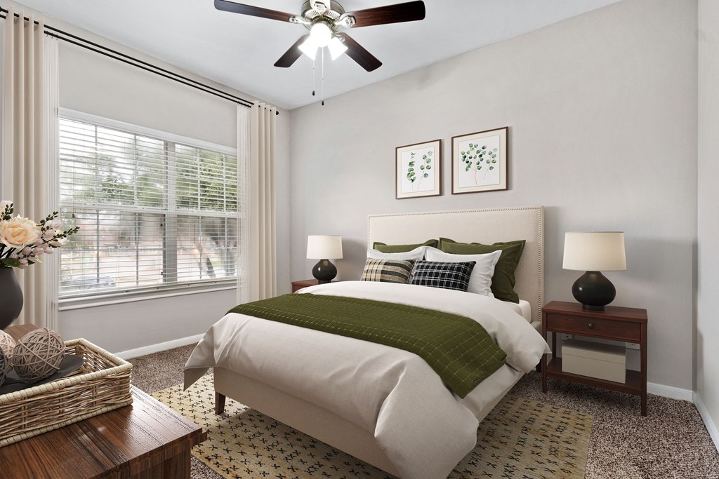 a bedroom with a bed and a ceiling fan