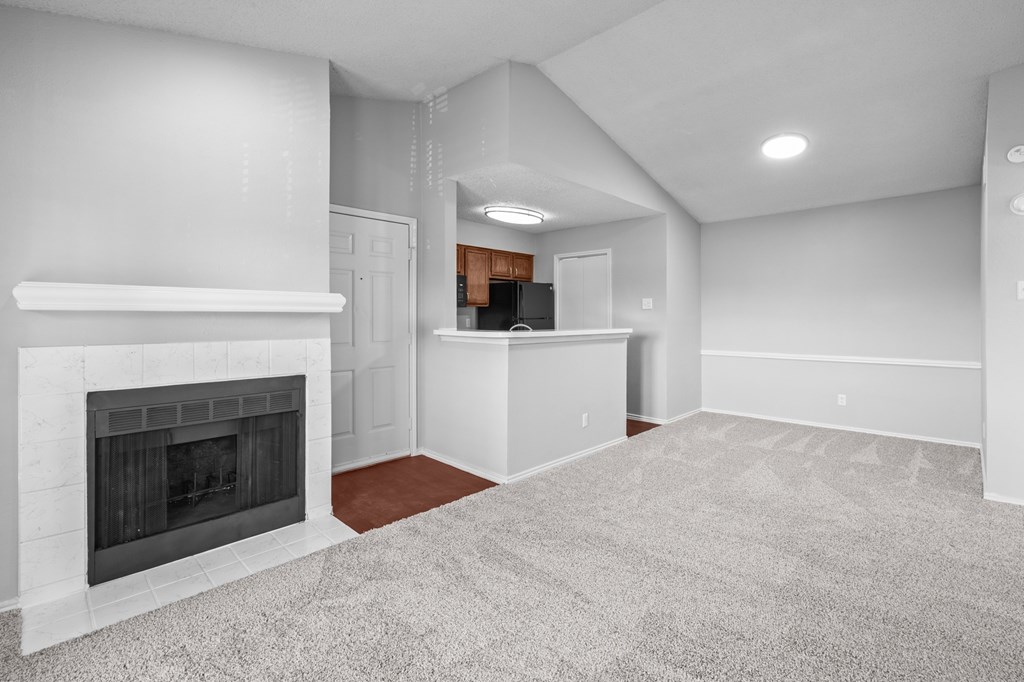 A living room with a fireplace and a carpet. at Preston Bend, Dallas, 75252