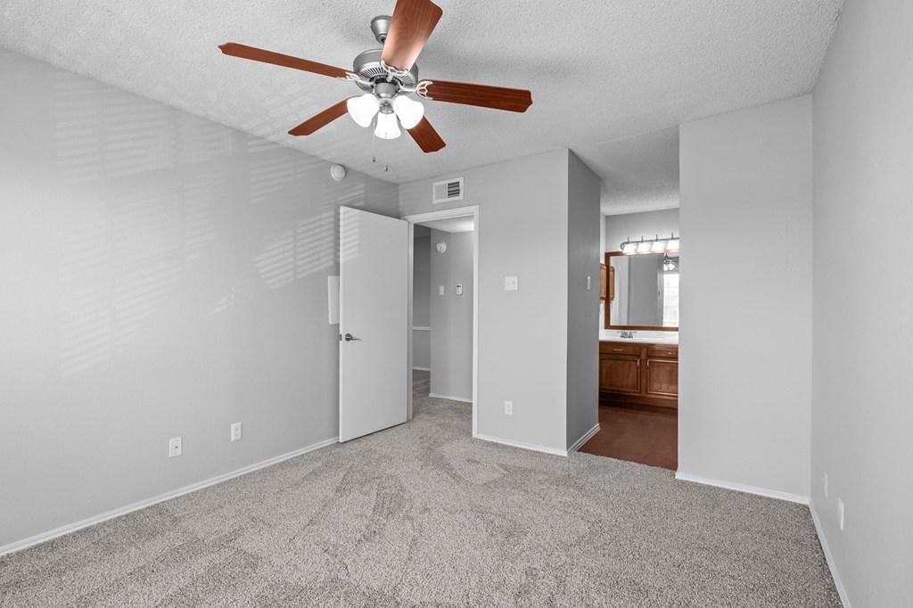 A room with a ceiling fan and carpeted floor. at Preston Bend, Dallas