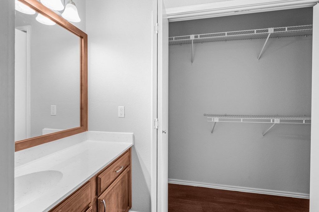A bathroom with a white counter top and a white sink. at Preston Bend, Dallas, TX
