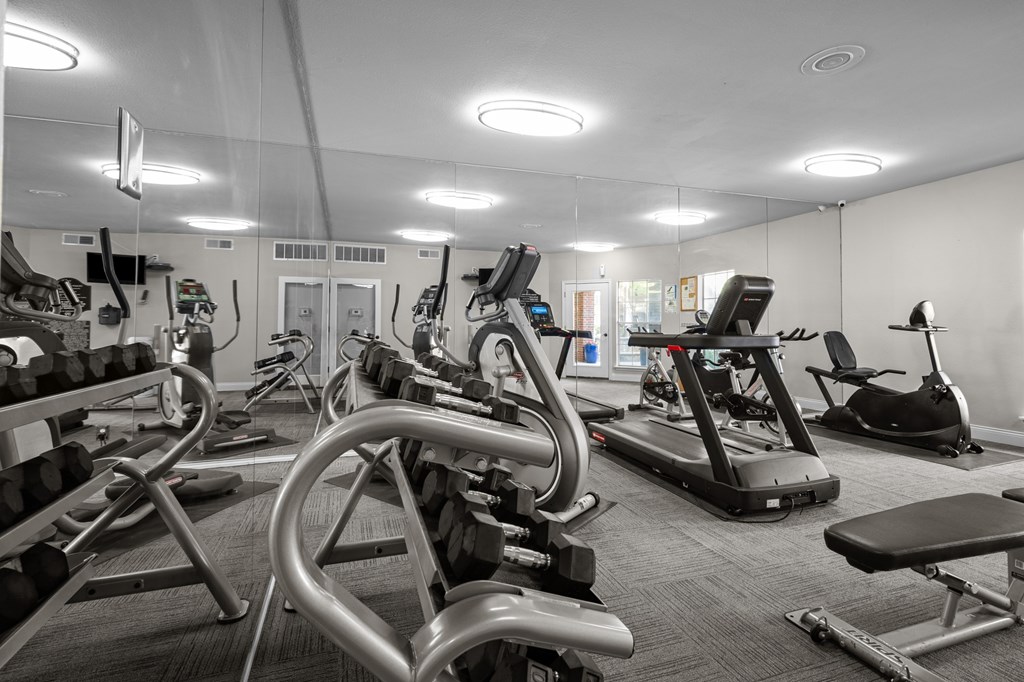 A gym with a variety of exercise equipment including treadmills, stationary bikes, and weight machines. A gym with a variety of exercise equipment including treadmills, stationary bikes, and weight machines. at Preston Bend, Dallas