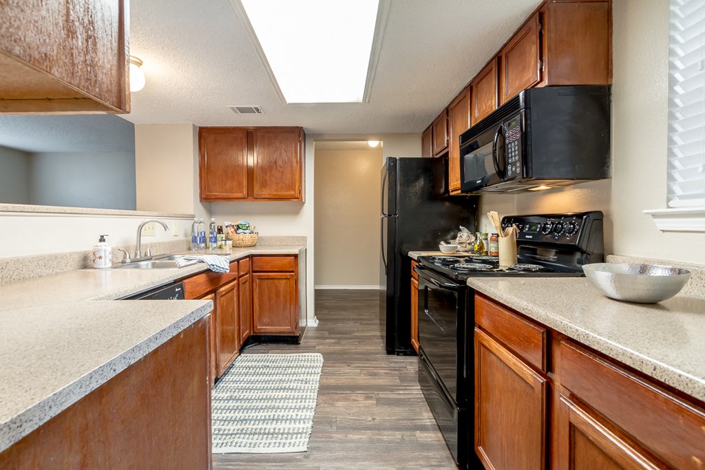 Wooden cabinets in kitchen at Amberly Village Townhomes, Garland