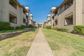 a grassy path between apartment buildings - Photo Gallery
