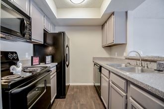 redesigned kitchen with stainless steel appliances and granite countertops at the preserve at great neck