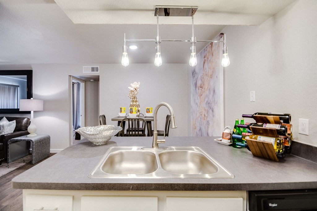 view of kitchen sink and living room with dining area at the preserve at greatstone