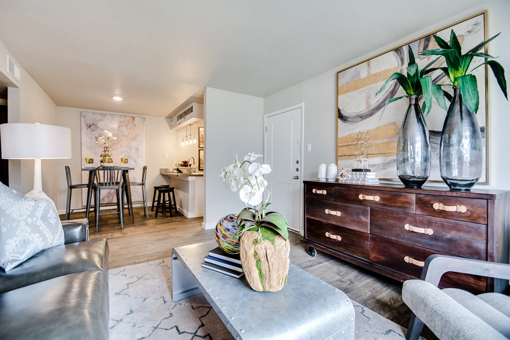 a living room with a couch and a table     and a kitchen