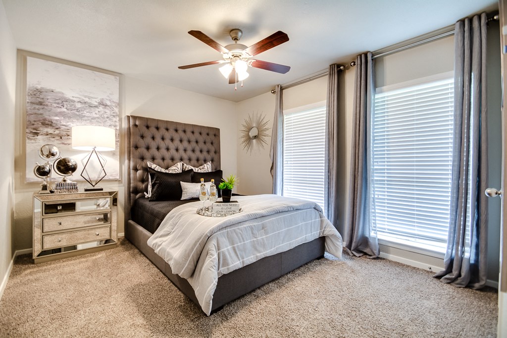 a bedroom with a bed and a ceiling fan