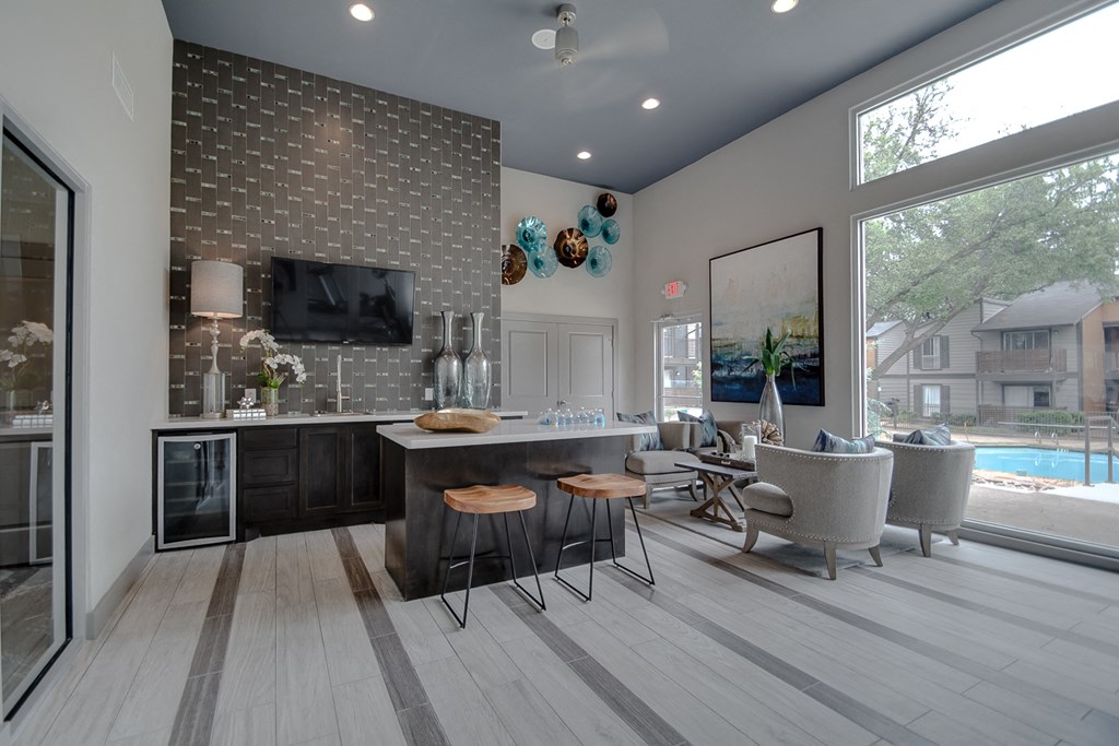 a kitchen and living room with a pool in the background