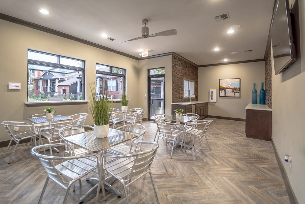 our clubhouse has a large seating area with tables and chairs