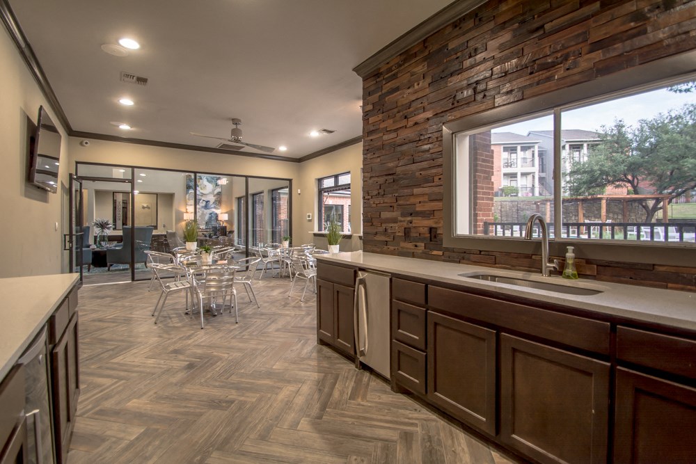 a kitchen with a large window and a table with chairs