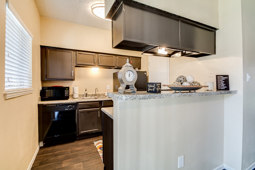 the view of a kitchen with an island and a counter top with a large window