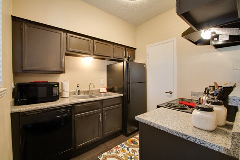 a kitchen with stainless steel appliances and granite counter tops