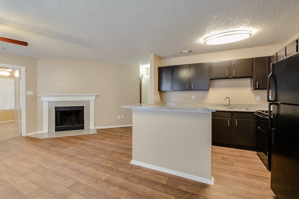 an open kitchen and living room with a fireplace