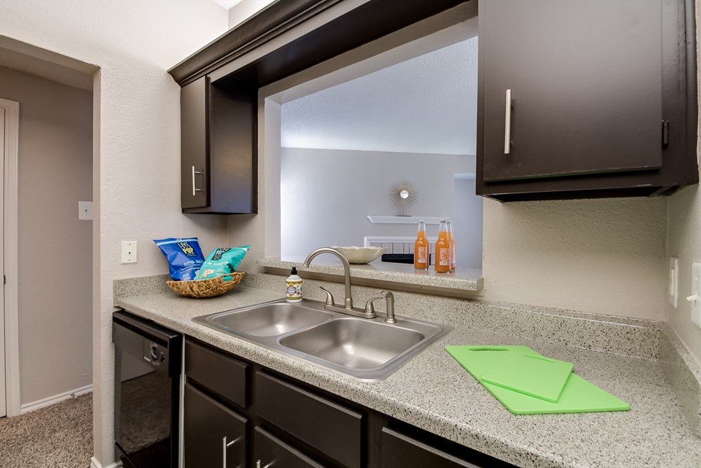 A kitchen with a sink and a window.