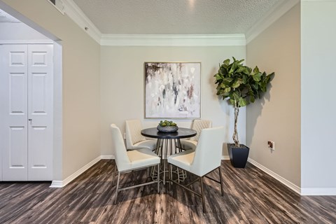 A dining room with a table and chairs.