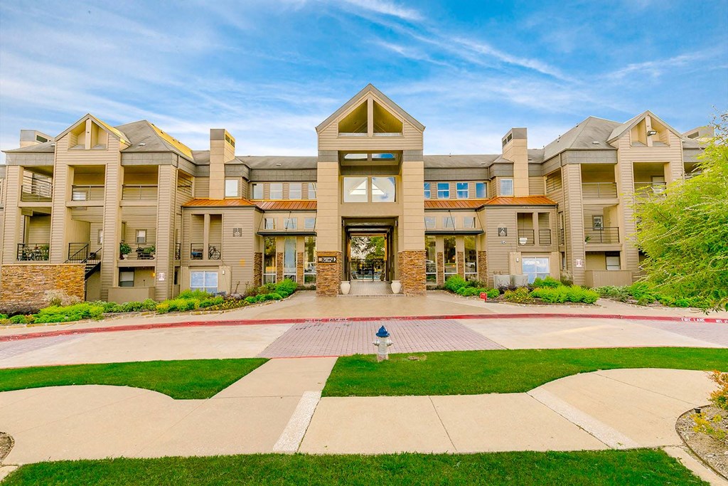 a large building with a lawn in front of it