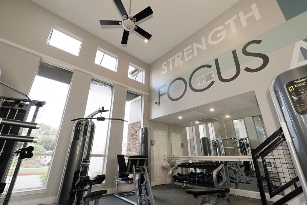 a home gym with a sign that says strength focus