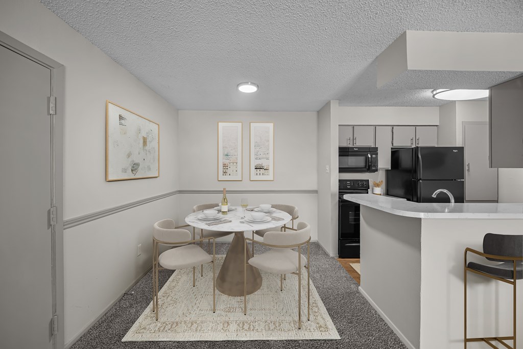 A modern dining room with a white table and chairs.