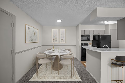 A modern dining room with a white table and chairs.