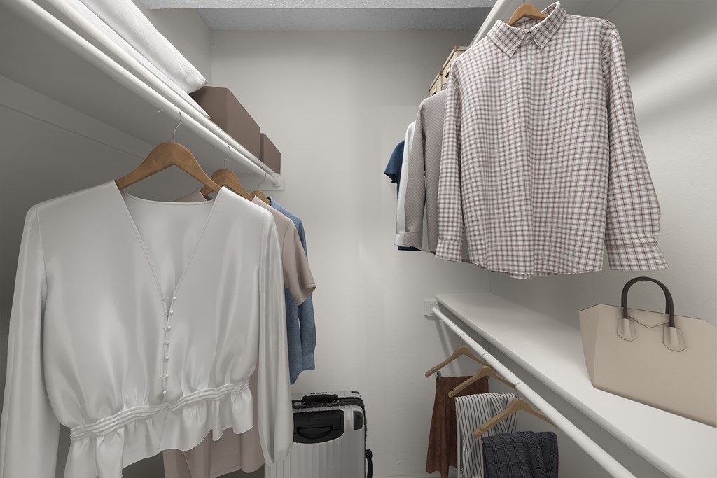 A white shirt with a belt is hanging on a hanger.