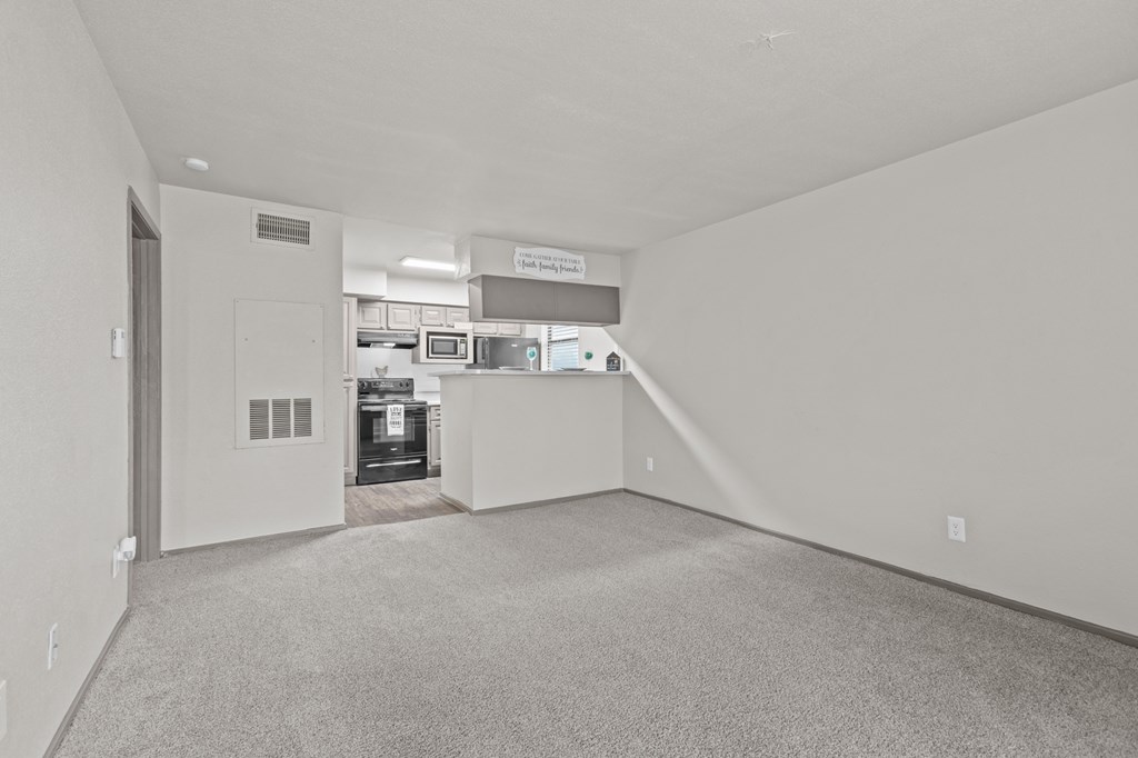 A large, empty room with a carpeted floor and white walls.at Rock 35, Texas