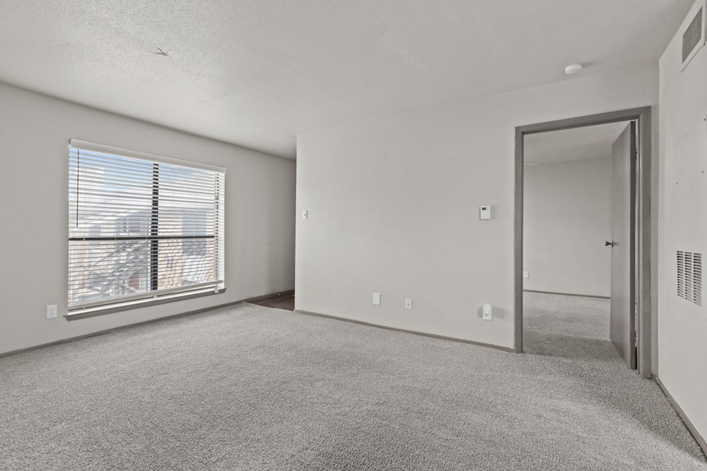 A room with a carpeted floor and a window with blinds.at Rock 35, Texas, 78681