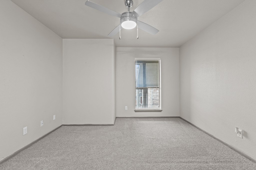 A room with a ceiling fan and a window with blinds.at Rock 35, Round Rock, 78681
