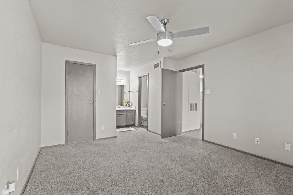 A spacious room with a ceiling fan and carpeted floor.at Rock 35, Round Rock, TX