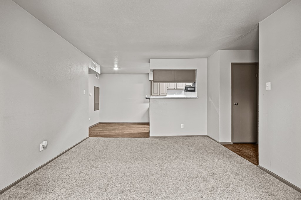 A spacious room with a carpeted floor and a window with blinds.at Rock 35, Round Rock, 78681