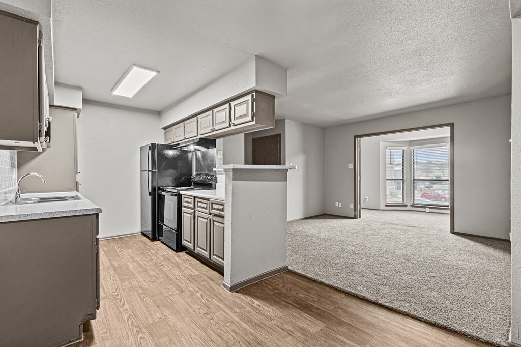 A kitchen with a refrigerator, microwave, and oven.at Rock 35, Round Rock, 78681